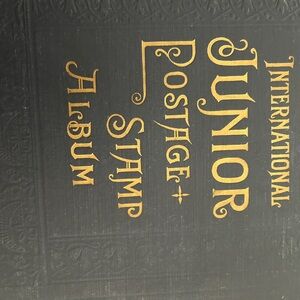International Black and Gold lettered Vintage 1939 stamp album loaded w/stamps